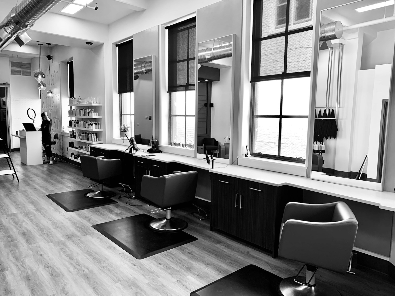 Stylist consulting with a client in a bright, modern salon
